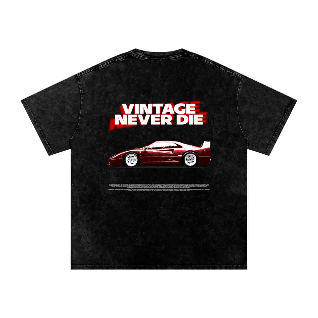 A black acid-wash t-shirt featuring a graphic print of a red sports car and the text 'VINTAGE NEVER DIE' in white and red, displayed on a solid white background.